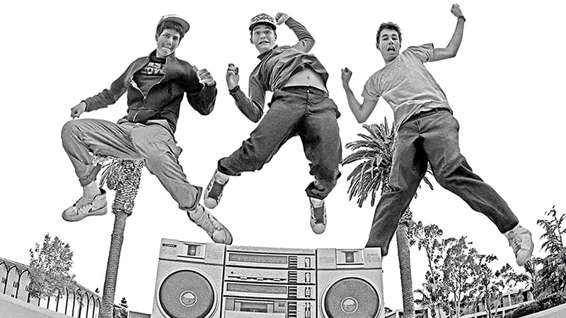 image of the beastie boys jumping behind a boombox taken from the ground's perspective looking up