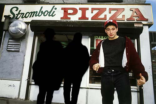 image of the Beastie Boys outside of a pizza restaurant with Ad-Rock in the foreground